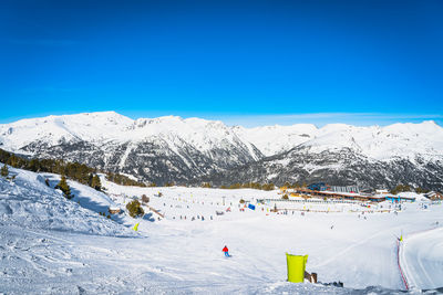 People, families, skiers and snowboarders relaxing and having fun in winter at soldeu, andorra