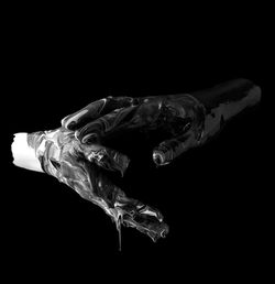 Close-up of human hand against black background