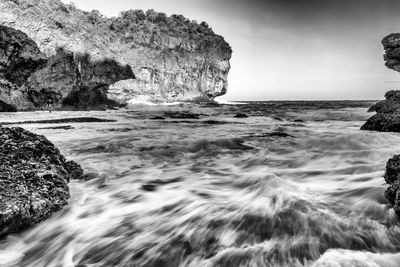 Scenic view of sea against rock formation