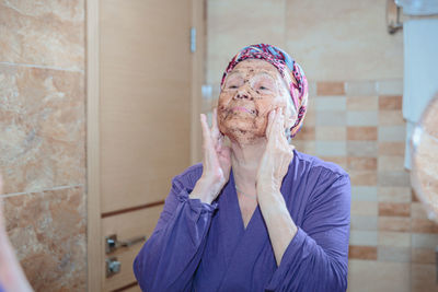 Elderly woman taking care of her face