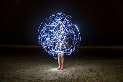 Woman playing with lantern at night