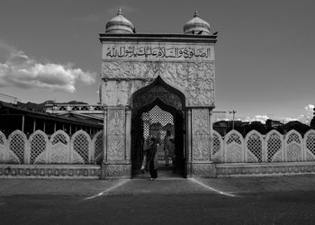 Man standing in front of historical building