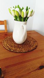 Close-up of flower vase on table at home