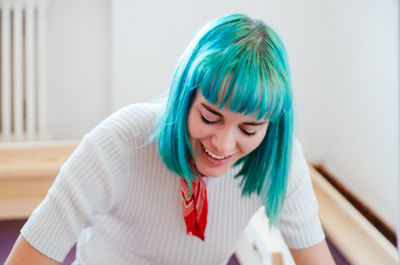 Close-up of smiling woman with dyed hair