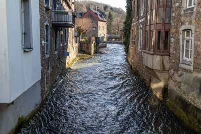 Stream vichtbach and historic buildings in stolberg, eifel, germany