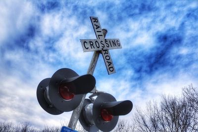 Low angle view of road sign against sky