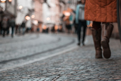 Low section of woman walking on street