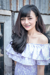 Portrait of happy woman standing outdoors