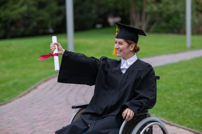 Portrait of woman wearing graduation gown