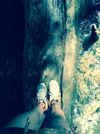 Low section of person standing in water