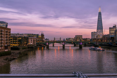 Bridge over river with buildings in background