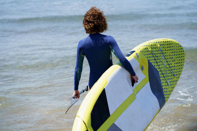 Rear view of woman in boat in sea