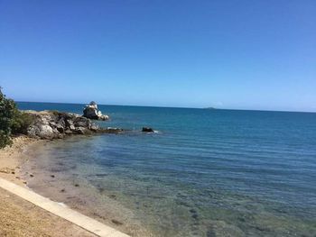 Scenic view of sea against clear blue sky