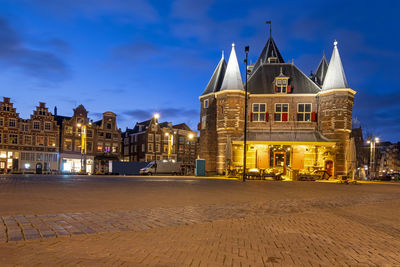 Illuminated building against sky at dusk