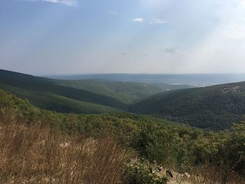 Scenic view of mountains against cloudy sky