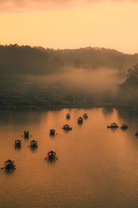 Scenic view of lake against sky during sunset