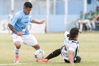 Full length of man playing soccer ball on field