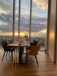 Chairs and tables in restaurant against sky