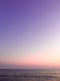 Scenic view of sea against clear sky at sunset