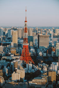 Aerial view of buildings in city against sky