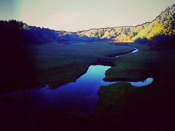 Scenic view of river amidst mountains against sky