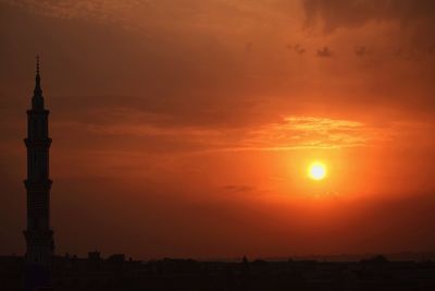 High section of tower against dramatic sky during sunset