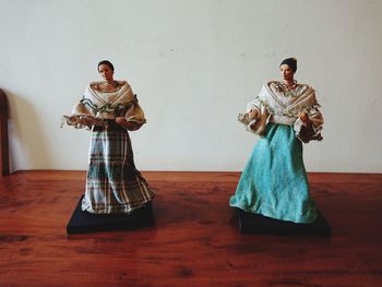 Man and woman standing against wall
