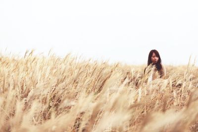 Mid adult woman standing on field