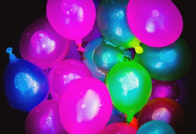 Close-up of multi colored balloons against blue background