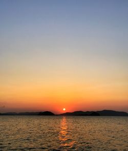 Scenic view of sea against clear sky during sunset