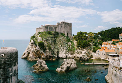 Panoramic view of sea and buildings against sky