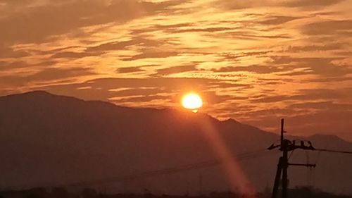 Scenic view of silhouette mountains against sky during sunset