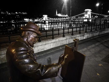 Side view of man using mobile phone in city