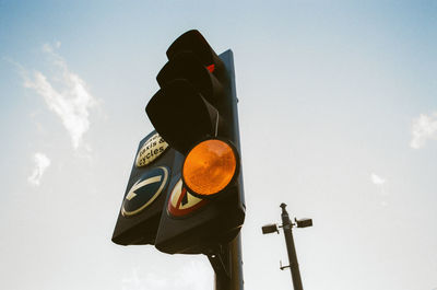 Low angle view of road sign against clear sky