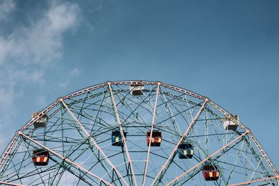 Low angle view of ferris wheel against sky