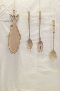 Wooden plate and spoons hanging on string