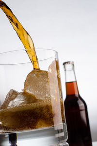 Close-up of beer glass bottle against white background