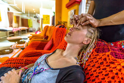 Woman getting head massage at salon