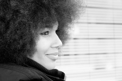 Close-up of young woman with curly hair in city