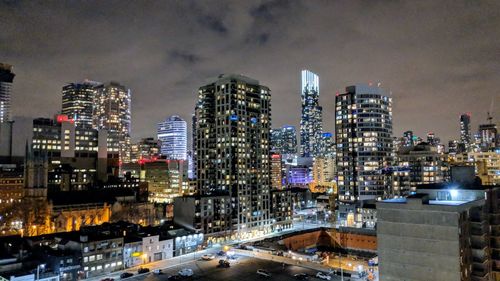 View of skyscrapers lit up at night