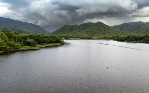 Scenic view of lake and mountains against sky