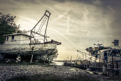 Abandoned ship in water against sky