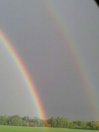 Scenic view of rainbow over landscape