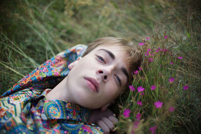 Portrait of man lying on grass