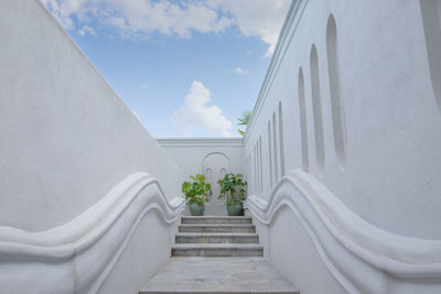 Staircase amidst buildings against sky