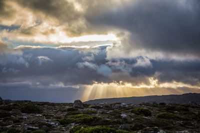 Scenic view of mountain against cloudy sky