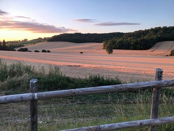 Scenic view of field against sky during sunset