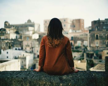 Rear view of woman looking at cityscape