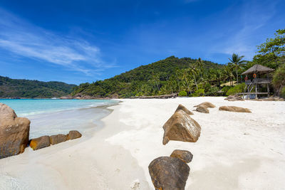 Scenic view of rocks on beach against sky