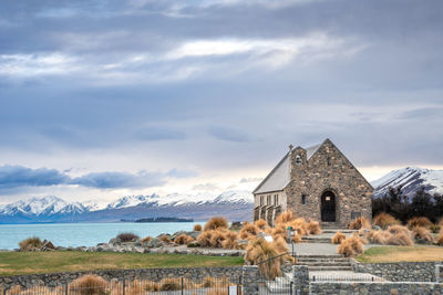 Sunrise view of the church of good shepherd with beautiful snow capped mountain range. 